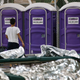 A young boy walks over to use the toilet while in his holding area.